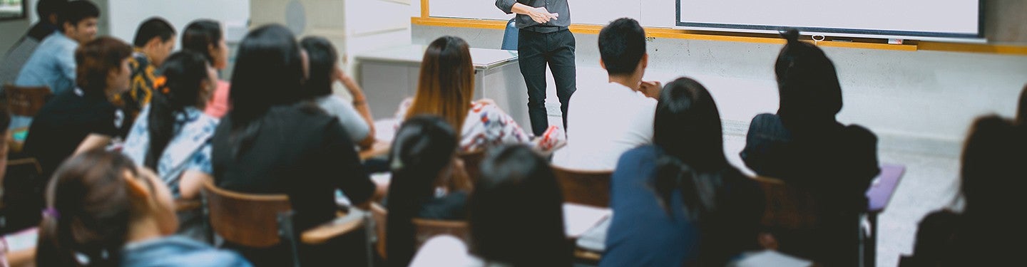 An image showing students in class from the perspective of the back of the classroom