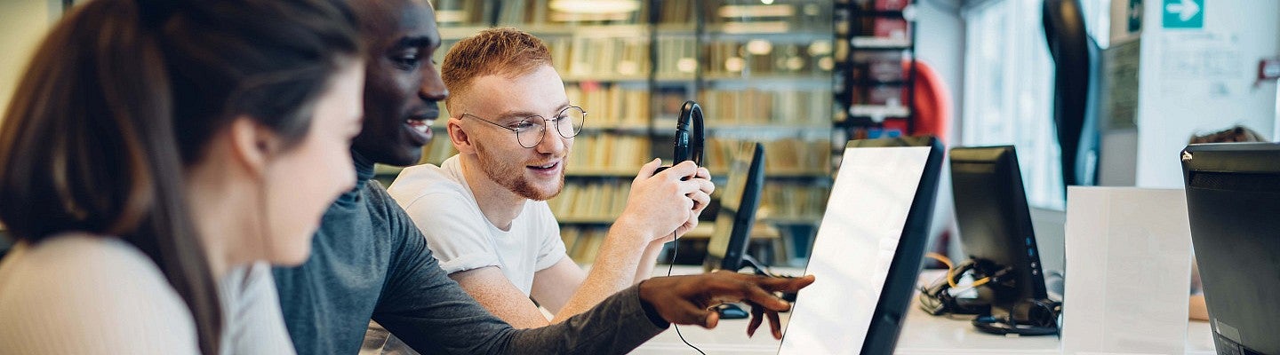 College students working together at a computer 