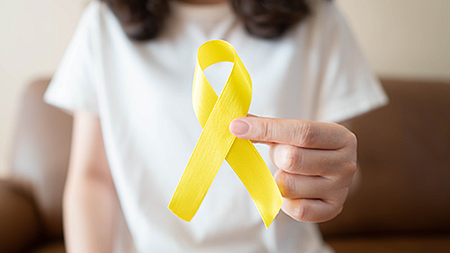 Woman holding a yellow ribbon