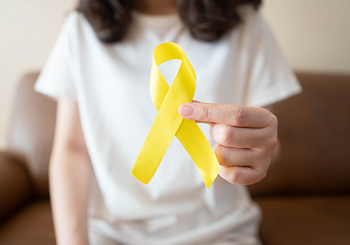 Woman holding a yellow ribbon