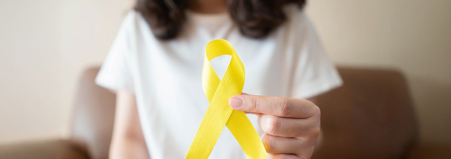 Woman holding a yellow ribbon