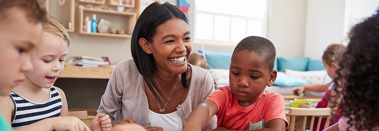 Elementary school teacher working with students 