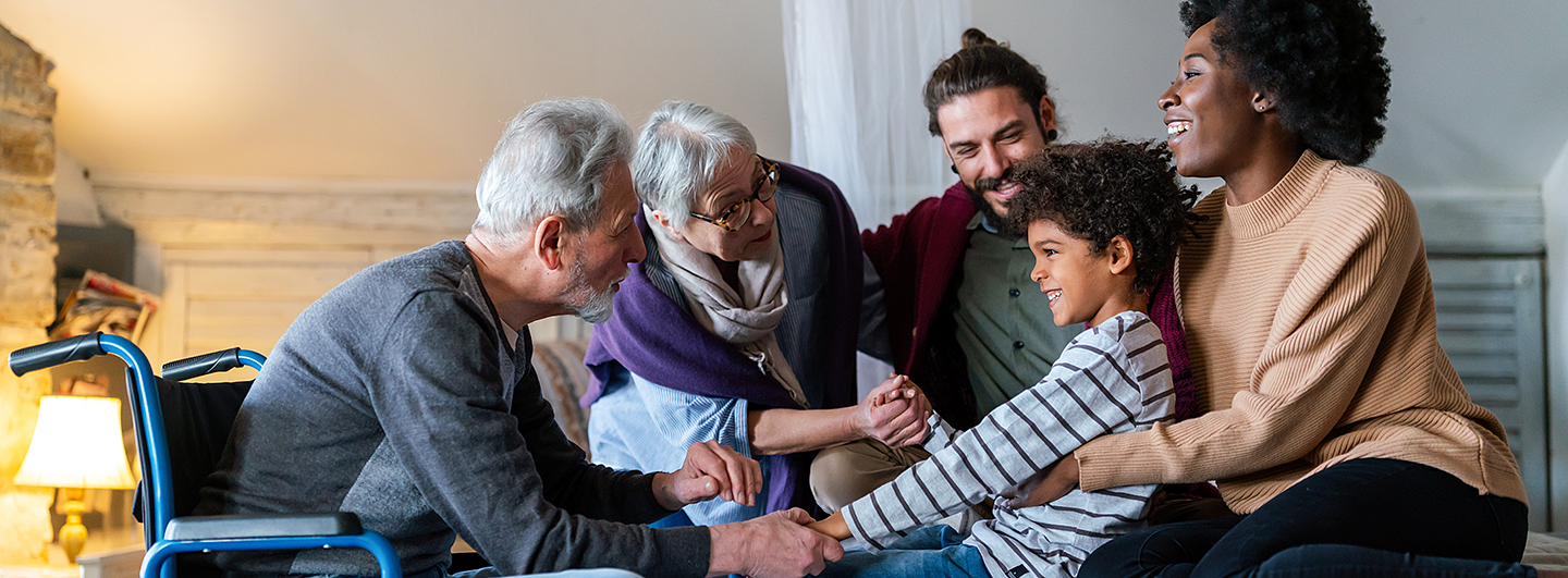 Parents and grandparents talking to a child