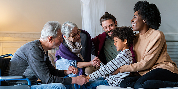 Parents and grandparents talking to a child