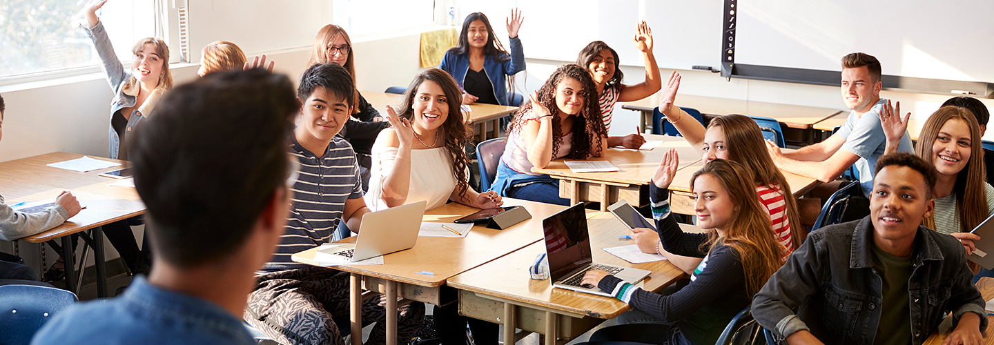 Teacher working with three small children in a classroom
