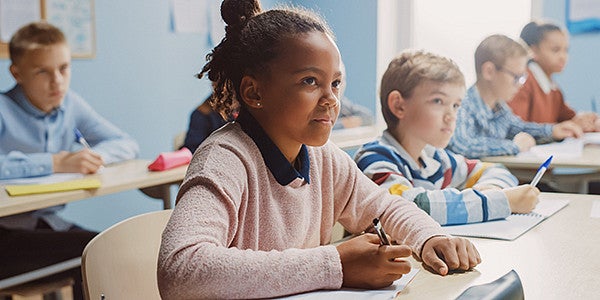 female elementary student listening in class