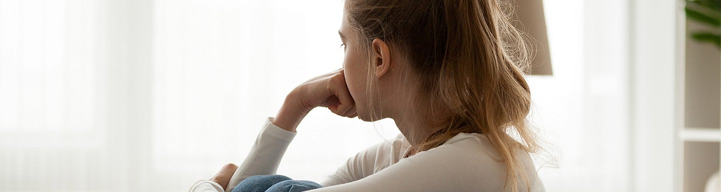 anxious teenager looking out window