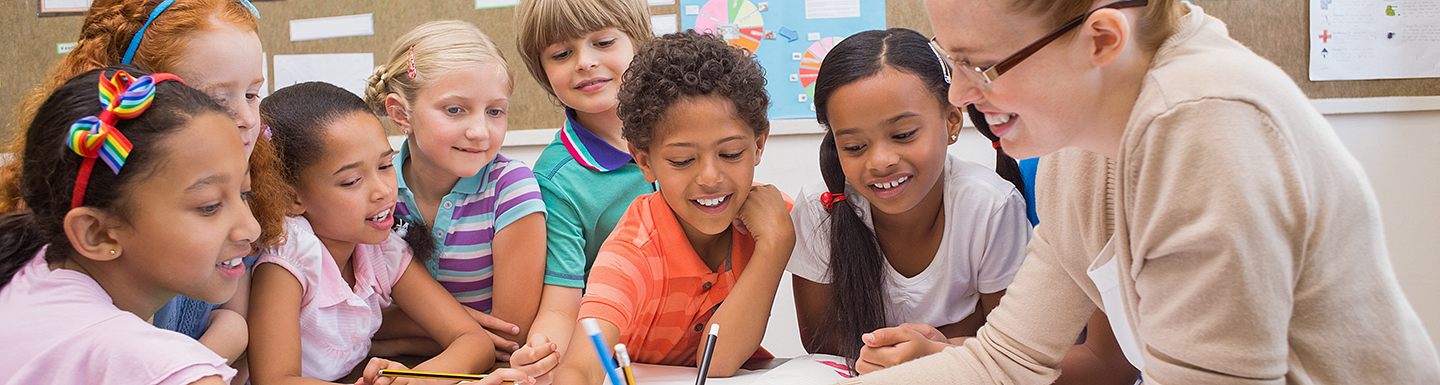 teacher showing students a lesson paper 