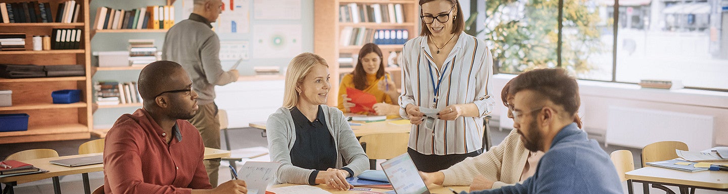 Teachers talking at a table 