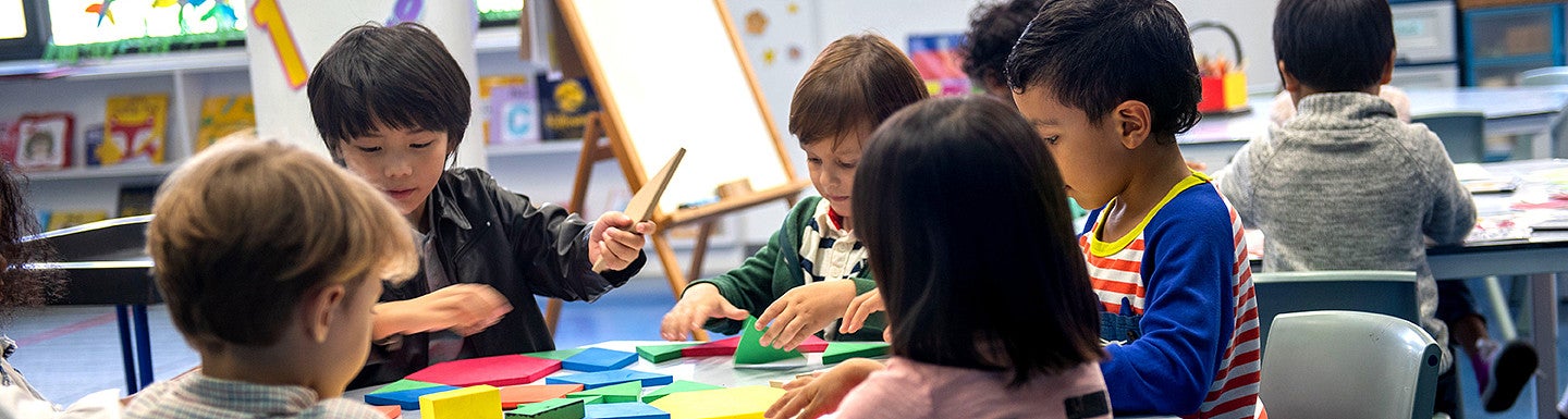 Children in classroom learning through creative play.