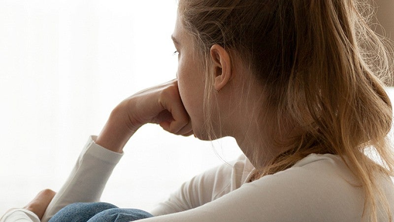 anxious teenager looking out window