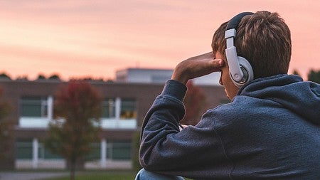 Depressed teen holding head