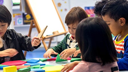 Children in classroom learning through creative play.